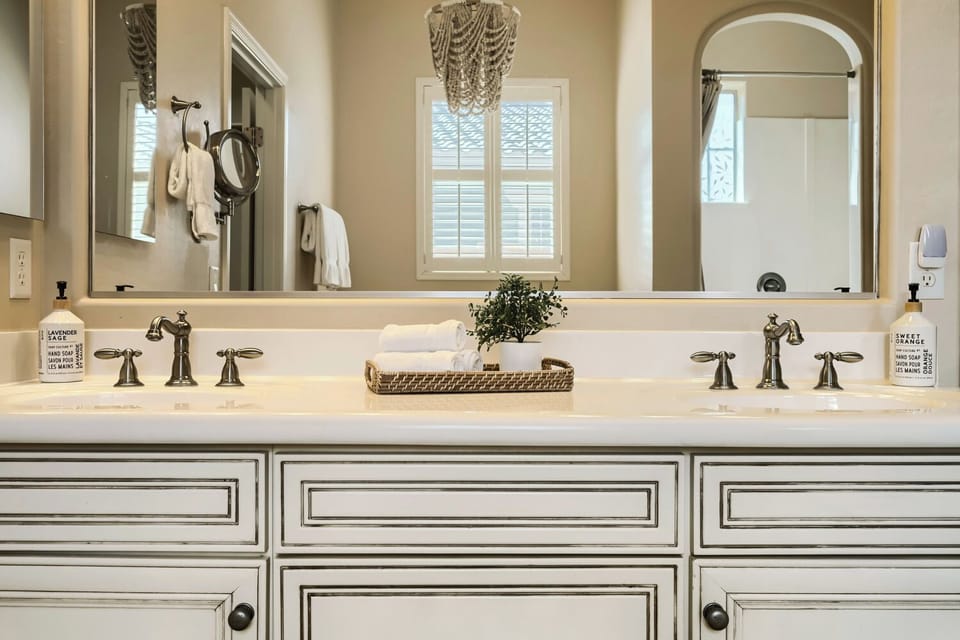 Indulge in this elegant dual-vanity bathroom