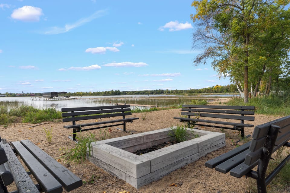 A peaceful lakefront area surrounds the property, with shaded benches and natural scenery creating a serene backdrop for your stay.