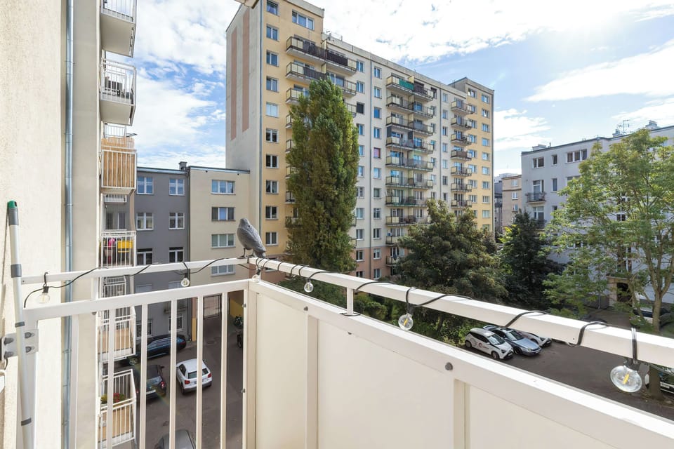 Enjoy a pleasant city view from the private balcony, overlooking the neighboring residential buildings and surrounding greenery.