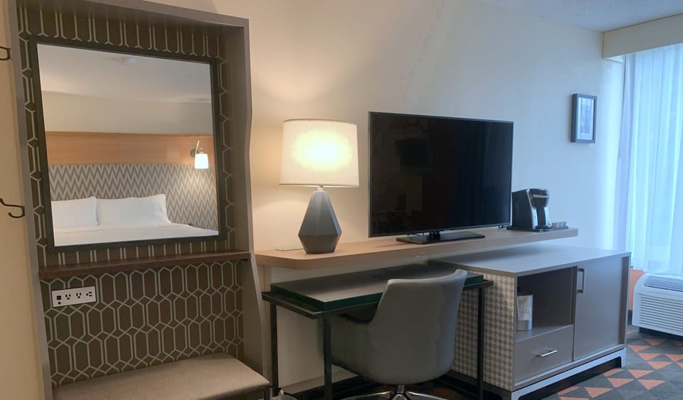 Hypo-allergenic bedding, desk, laptop workspace, blackout drapes
