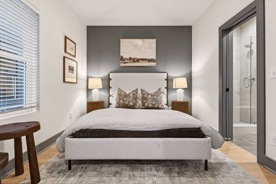 Bedroom 1 features a comfortable queen bed, dresser, closet, and a private attached bathroom. Located on the first floor.