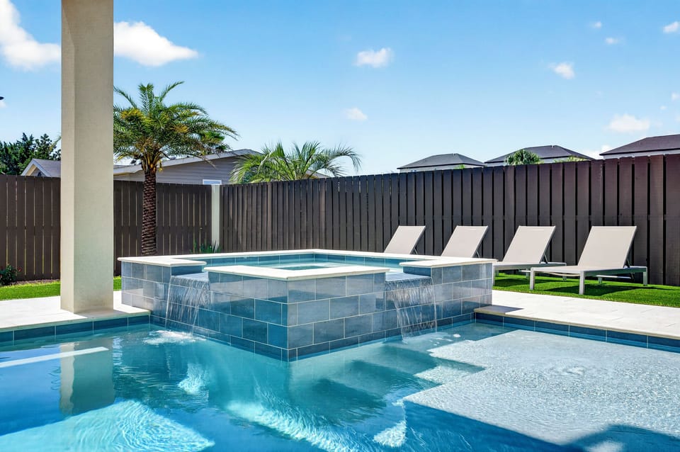 Unwind in your very own piece of paradise: Enjoy custom fire pit surrounded by Adirondack seating, lush turf, and covered patio with outdoor kitchen and dining for 6. Splash around in the heated saltwater pool and spa to create relaxing coastal memories.