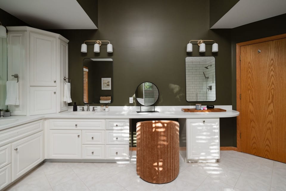 Two sinks, two mirrors, zero morning queue. Spa-like bathroom with dual vanities and elegant makeup station