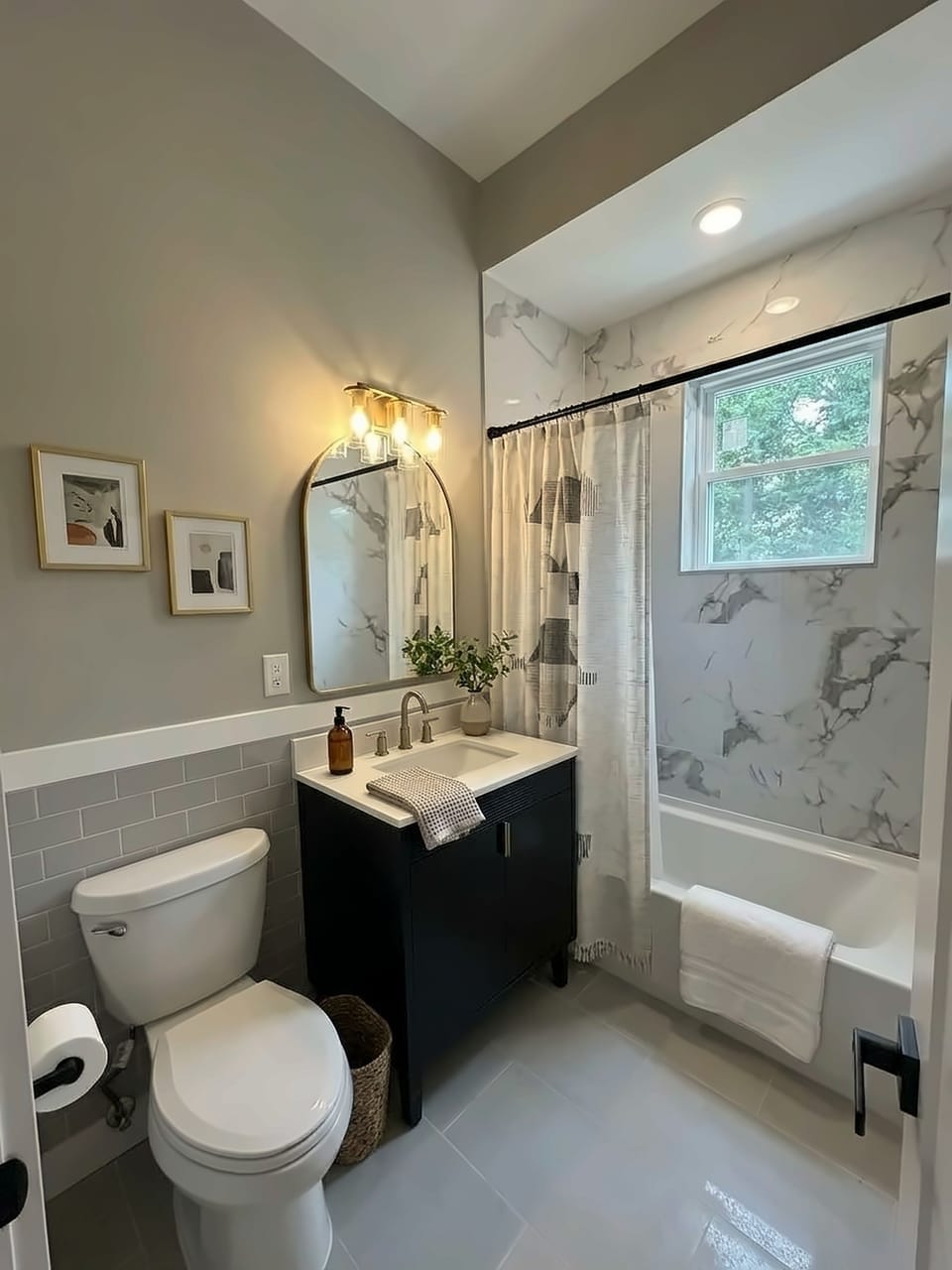 Bright modern bathroom with tub, marble-look tile, and natural light