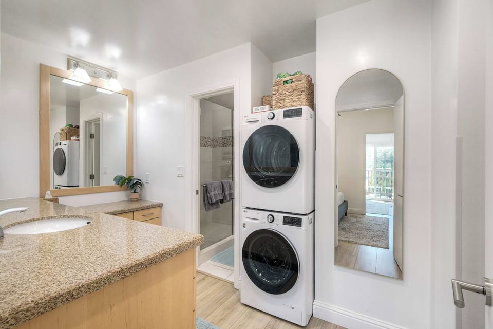 Refresh in the full bathroom with a walk-in shower and stacked washer and dryer