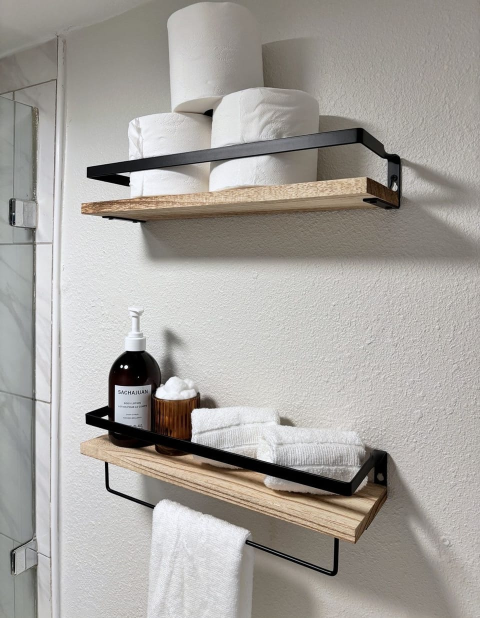 Modern bathroom shelves stocked with fresh towels and essentials