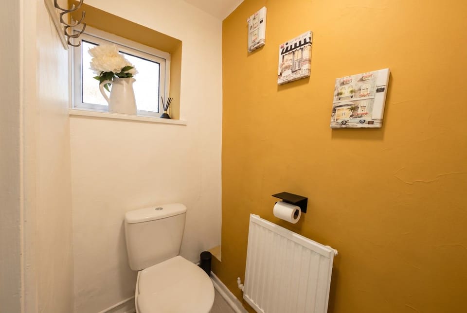 Separate WC with a frosted window and towel hooks.