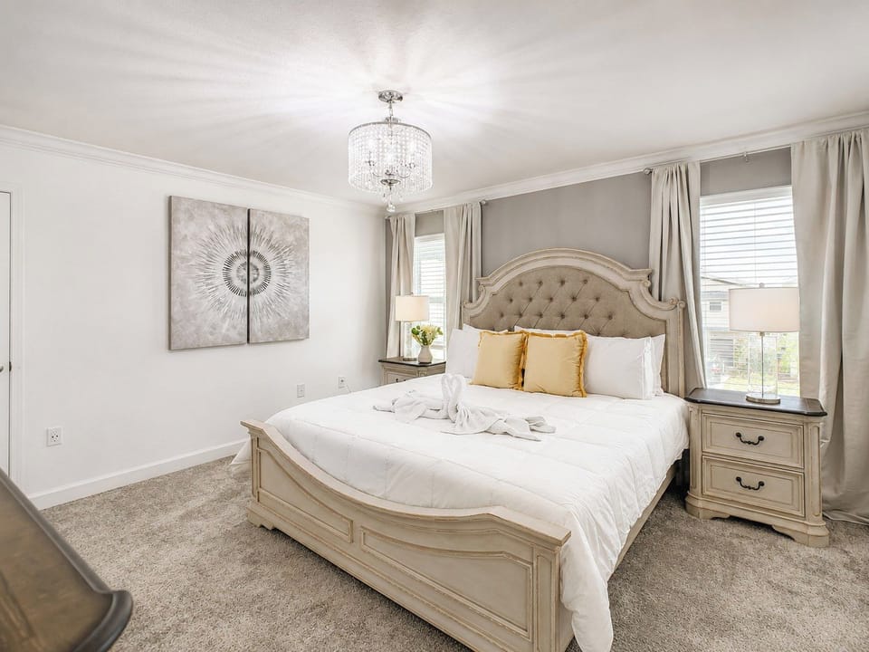 Elegant Bedroom with Tufted Headboard and Crystal Chandelier