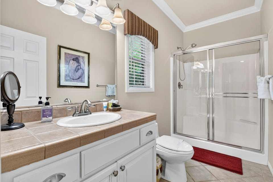 Refresh in the ensuite bathroom with a bright walk-in glass shower.