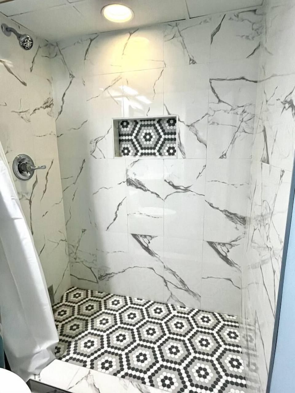 Step-in tiled shower in master bath. Shower is oversized for comfort.