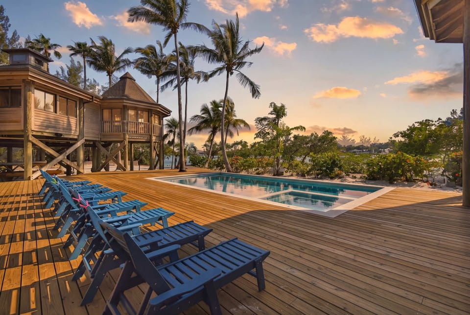 Stretch out on cushioned loungers beside the pool and spa while palm trees sway overhead. A relaxing tropical retreat for the whole group.