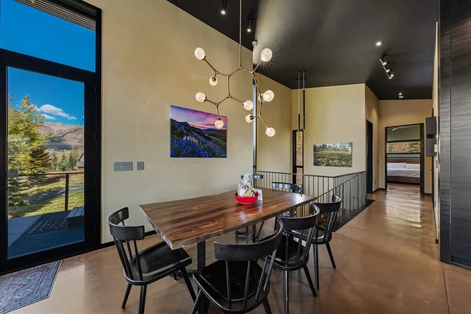 Warm light pours through tall windows onto the dining area. Enjoy mountain views over breakfast and linger over dinner in a space that feels bright and welcoming.