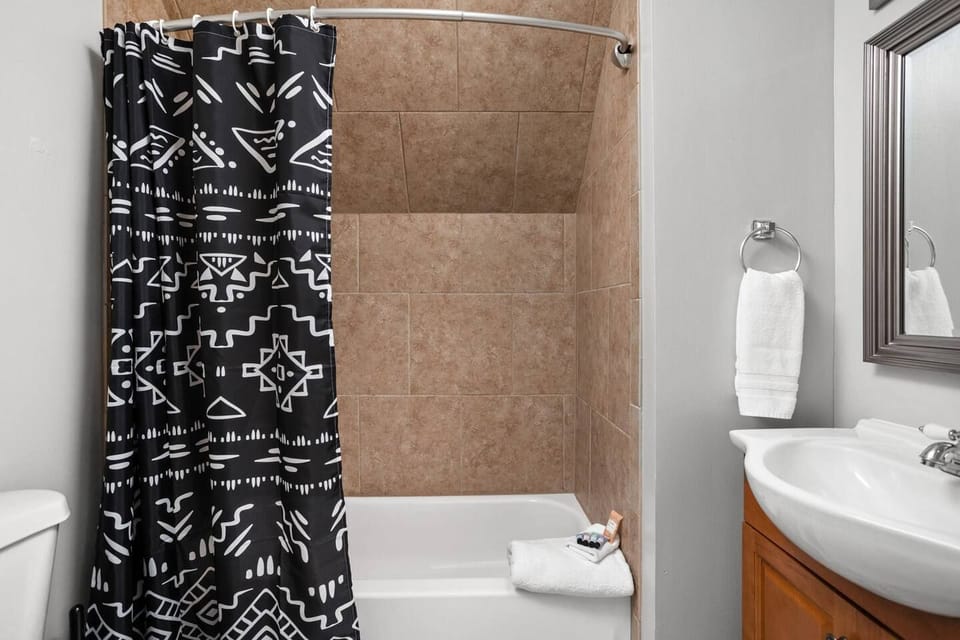 Fully stocked bathroom with updated fixtures. Travel size shampoo, conditioner, and bodywash provided. One towel and wash cloth per guest provided. 