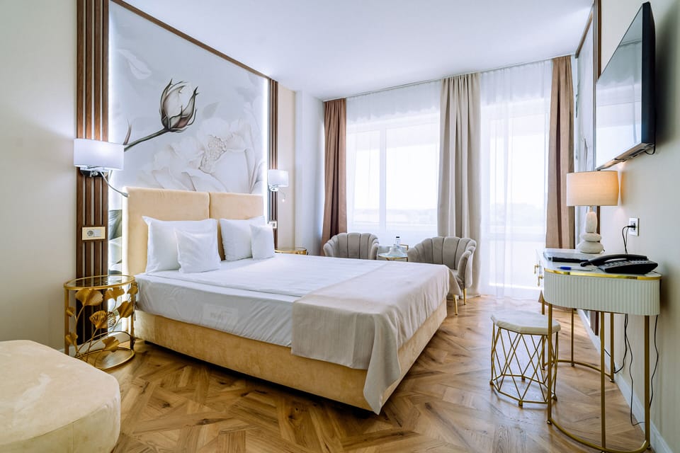 Deluxe Double Room, River View | Minibar, in-room safe, desk, laptop workspace