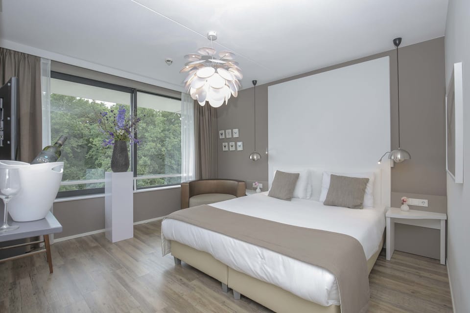 Deluxe Suite, Balcony, River View | In-room safe, desk, iron/ironing board, cribs/infant beds