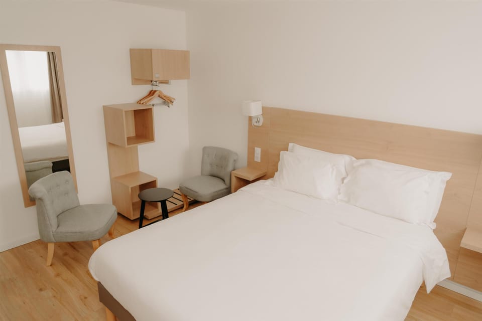 Premium bedding, desk, laptop workspace, blackout drapes
