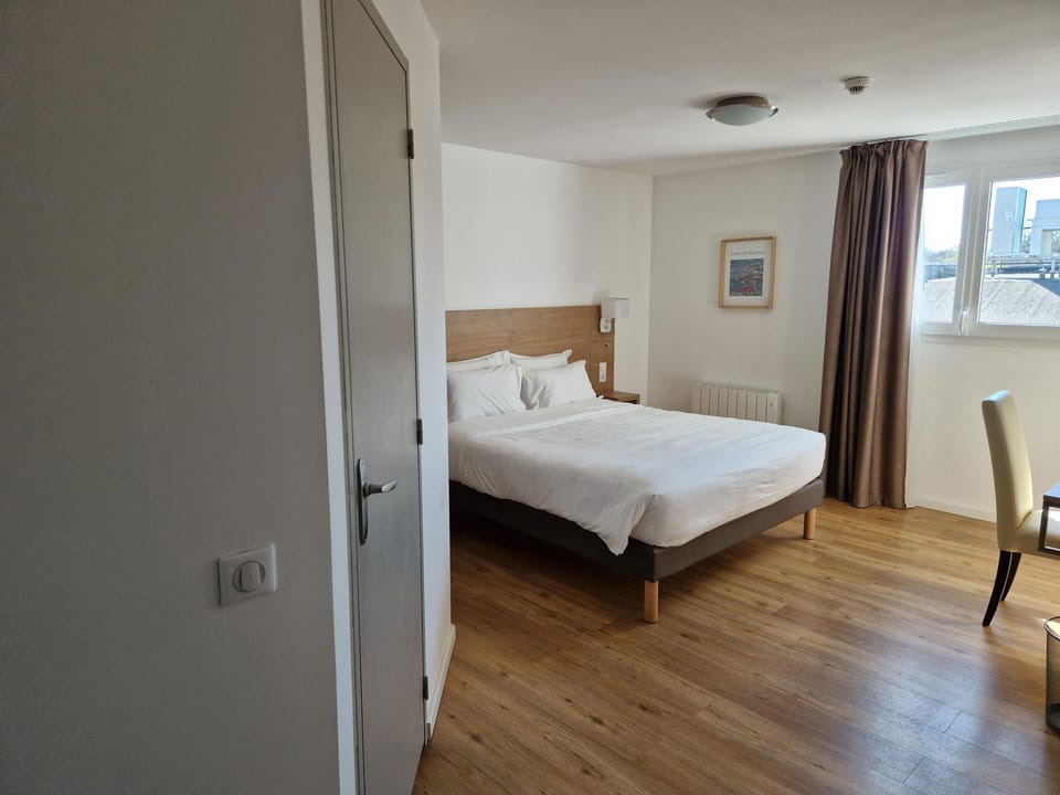 Premium bedding, desk, laptop workspace, blackout drapes