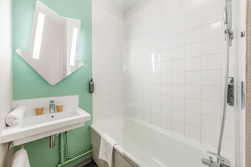 Bathtub, eco-friendly toiletries, towels, soap