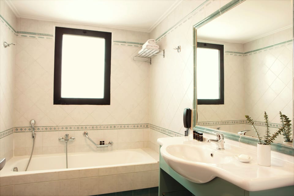 Premium Suite, Partial Sea View | Bathroom | Bathtub, deep soaking tub, eco-friendly toiletries, hair dryer