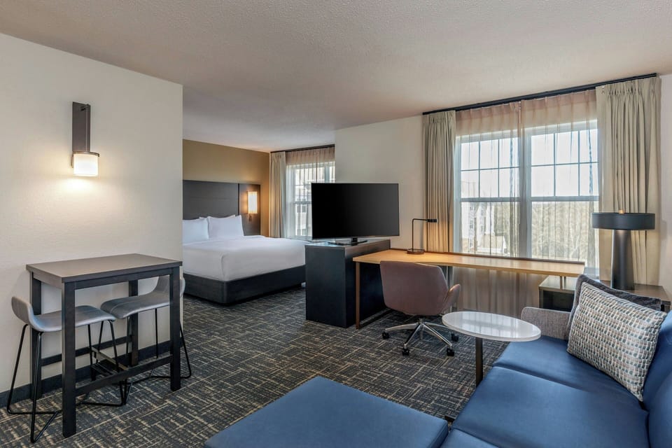 Premium bedding, desk, laptop workspace, blackout drapes