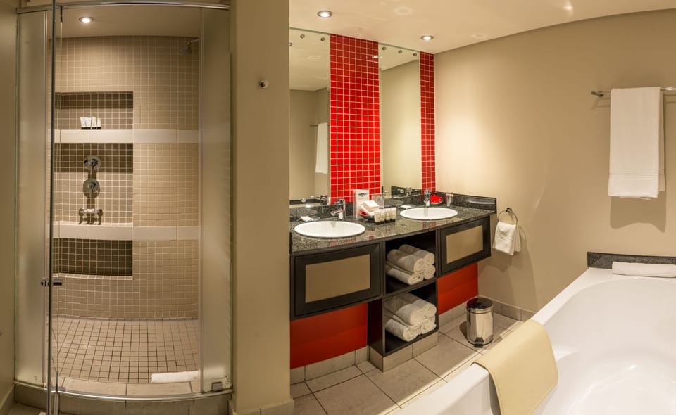 Separate tub and shower, designer toiletries, hair dryer, towels