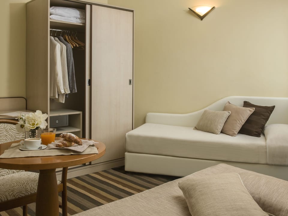 Triple Room | Minibar, in-room safe, desk, iron/ironing board
