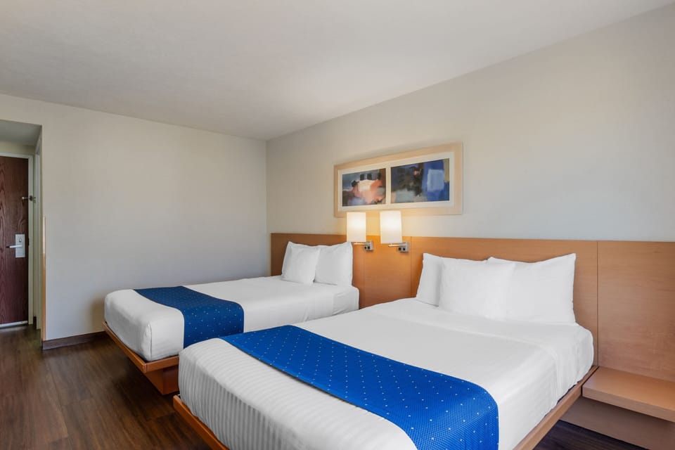 Room, 2 Double Beds | Down comforters, desk, blackout drapes, iron/ironing board