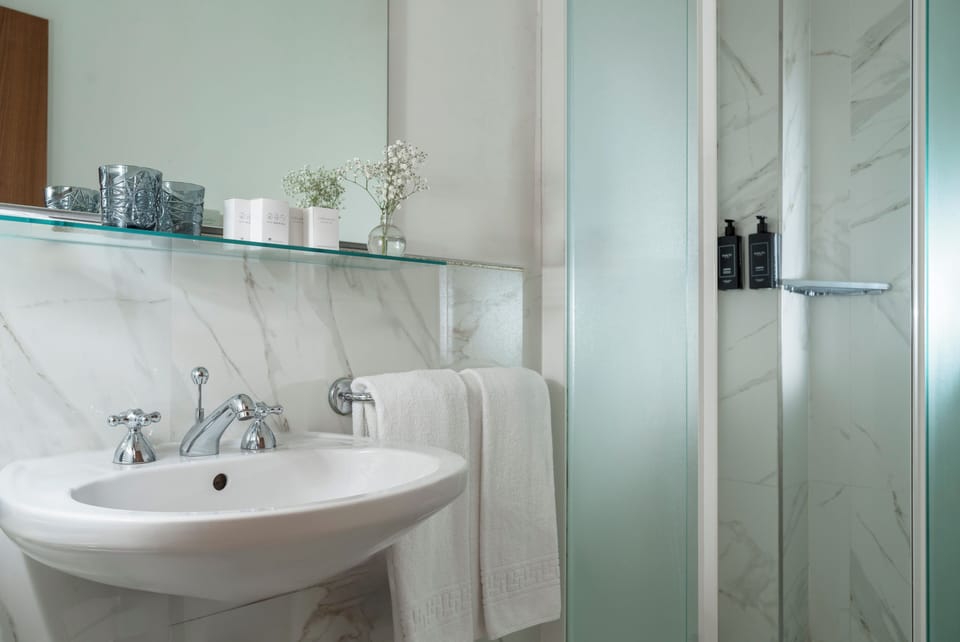 Shower, rainfall showerhead, designer toiletries, hair dryer