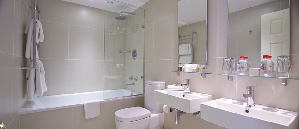Designer toiletries, hair dryer, towels, toilet paper