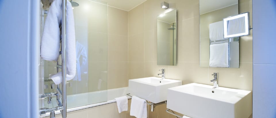 Designer toiletries, hair dryer, towels, toilet paper