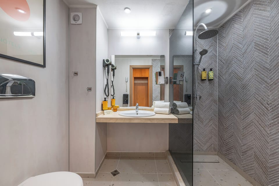 Bathtub, eco-friendly toiletries, hair dryer, towels