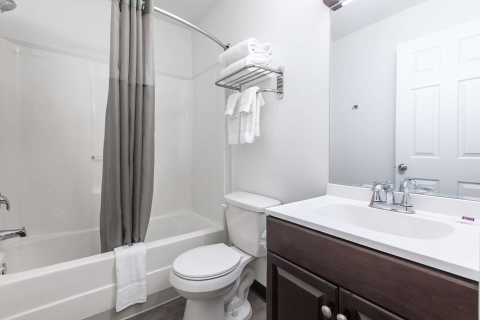 Bathtub, towels, soap, toilet paper