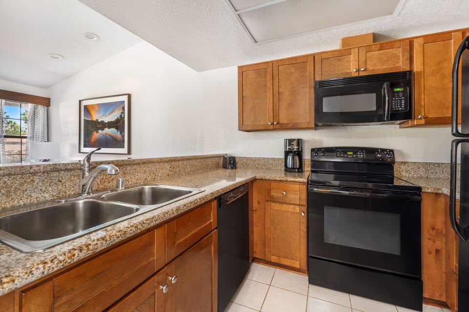 Fridge, microwave, coffee/tea maker, cookware/dishes/utensils