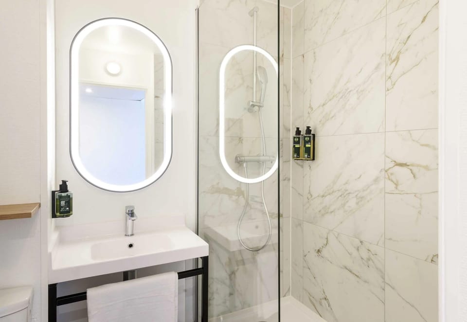Bathtub, eco-friendly toiletries, hair dryer, towels