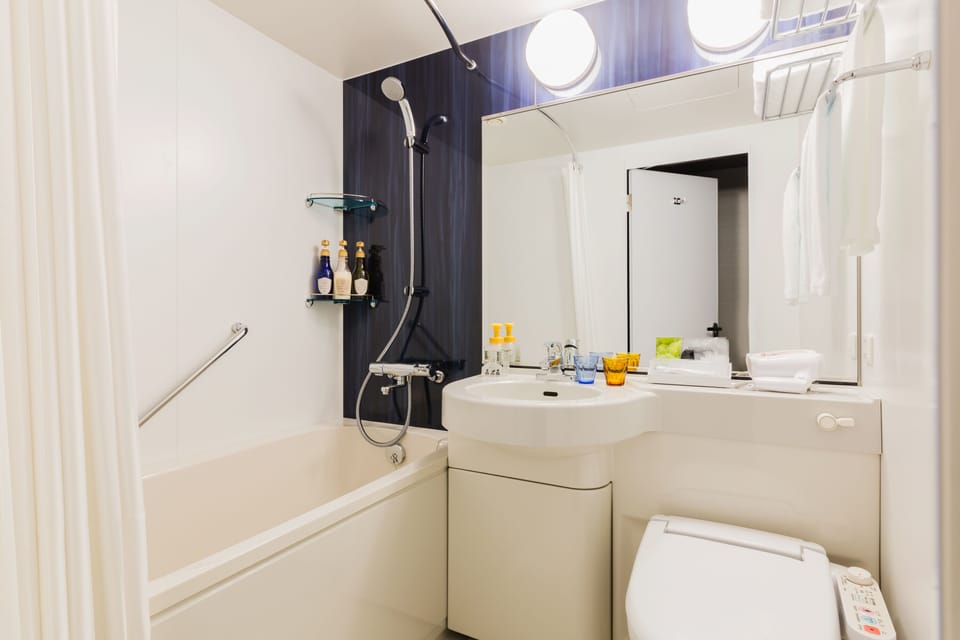 Combined shower/tub, free toiletries, hair dryer, slippers