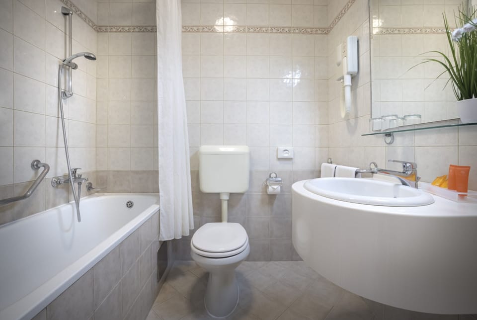 Bathtub, hair dryer, towels, soap
