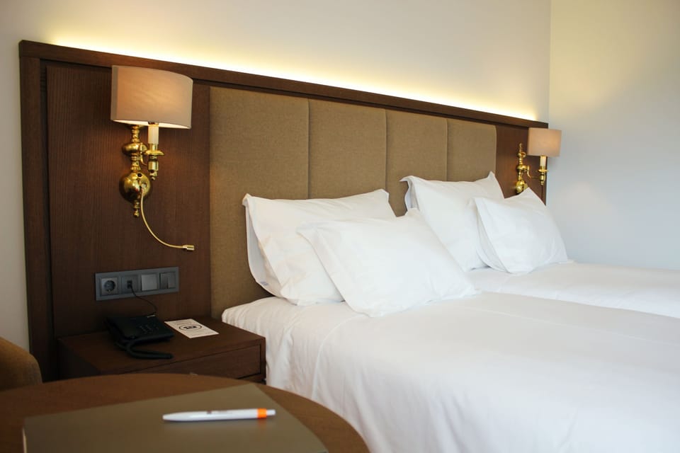 Twin Room | Minibar, in-room safe, desk, soundproofing