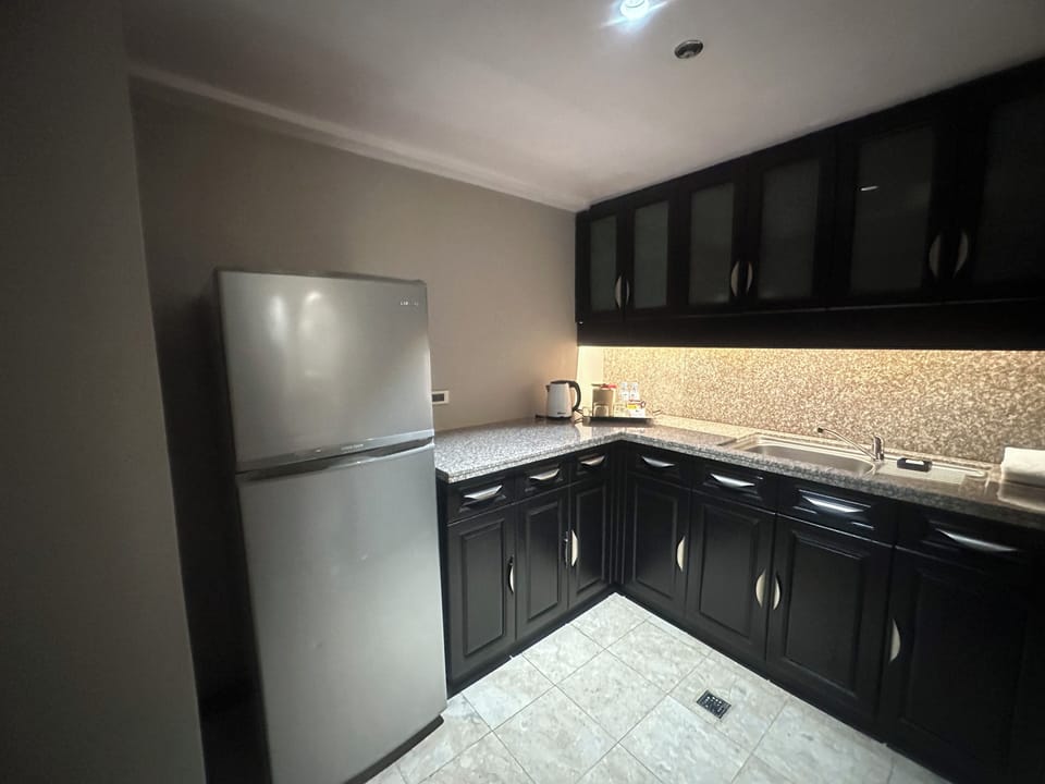 One-Bedroom Suite | Private kitchen | Fridge, coffee/tea maker, electric kettle, highchair
