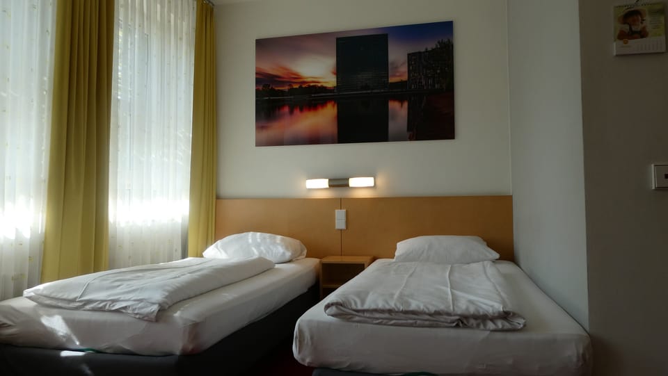 Twin Room | Desk, iron/ironing board, bed sheets
