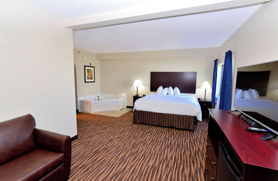 Premium bedding, desk, laptop workspace, blackout drapes