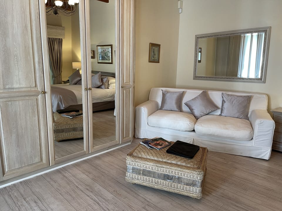 Deluxe Suite, Garden View | Living area | Plasma TV, DVD player