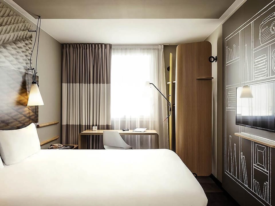 Premium bedding, desk, laptop workspace, blackout drapes