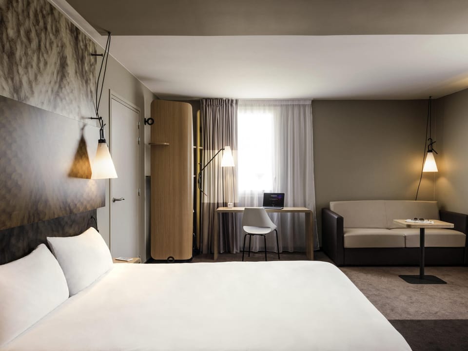 Premium bedding, desk, laptop workspace, blackout drapes