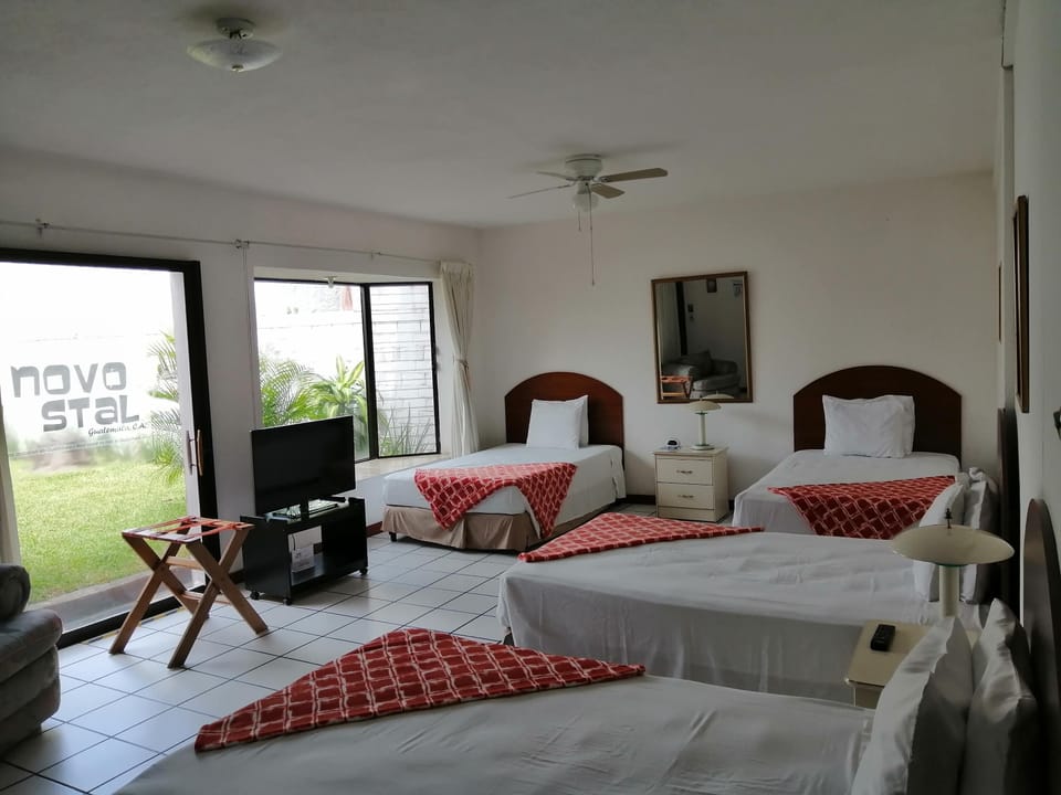 Standard Quadruple Room, 4 single beds  | In-room safe, desk, free WiFi, bed sheets