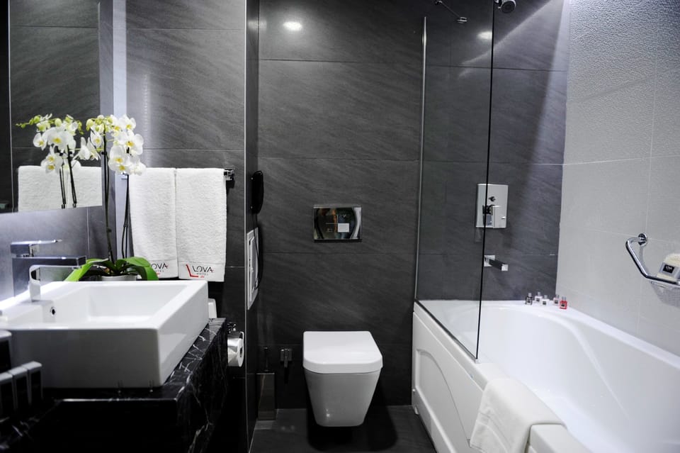 Bathtub, deep soaking tub, designer toiletries, hair dryer