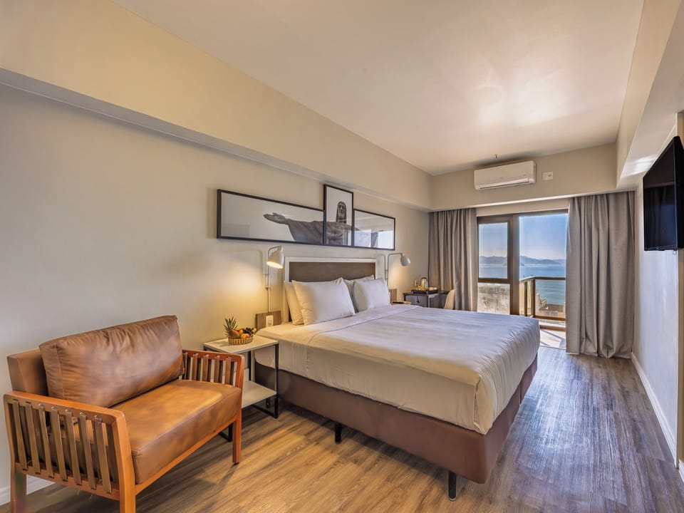 Deluxe Double Room, Partial Sea View | Hypo-allergenic bedding, pillowtop beds, minibar, in-room safe