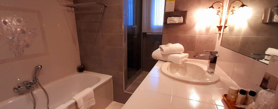 Separate tub and shower, free toiletries, hair dryer, slippers