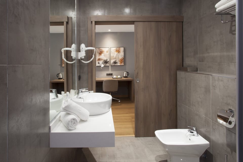 Eco-friendly toiletries, hair dryer, slippers, towels