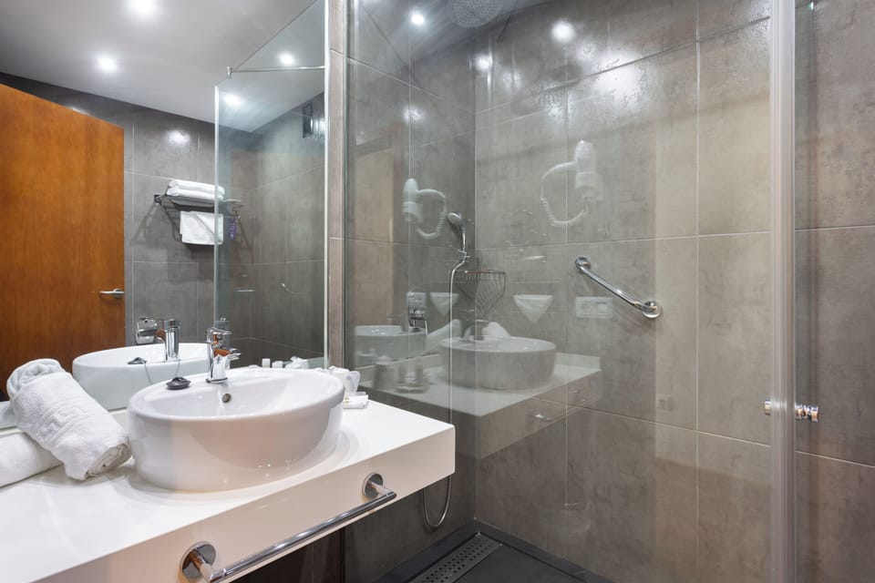 Eco-friendly toiletries, hair dryer, slippers, towels