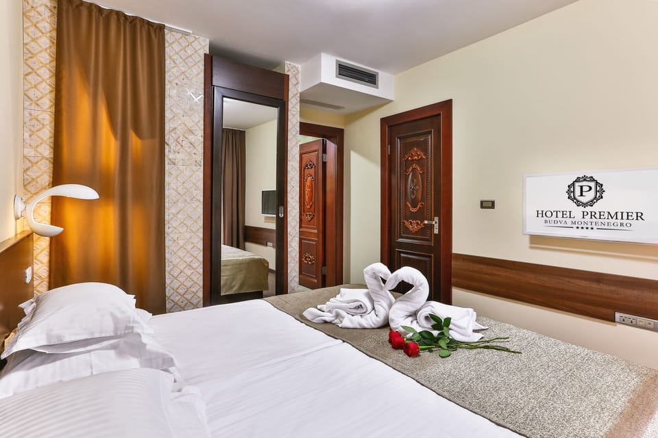 Family Suite, 2 Bedrooms | Minibar, in-room safe, soundproofing, iron/ironing board